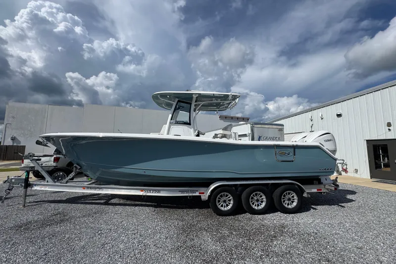 The Image of 2023 Sea Hunt Gamefish 30 Coffin Box boat on trailer, parked outdoors. - 1