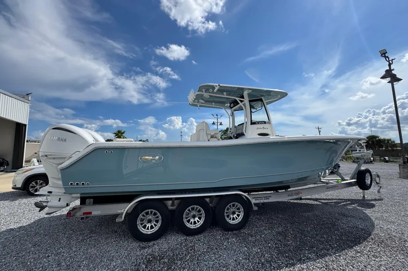 Slide: The Image of 2023 Sea Hunt Gamefish 30 Coffin Box boat on trailer under blue sky. - 10