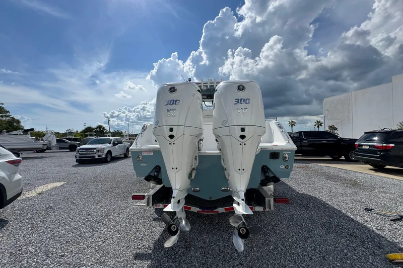 Slide: The Image of 2023 Sea Hunt Gamefish 30 Coffin Box with dual outboard engines in a parking lot. - 13