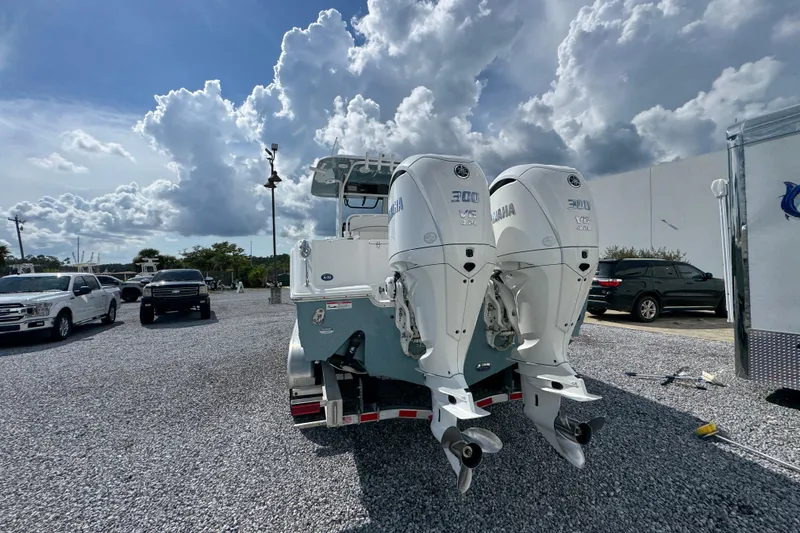 Slide: The Image of 2023 Sea Hunt Gamefish 30 Coffin Box with dual Yamaha engines in a parking lot. - 14