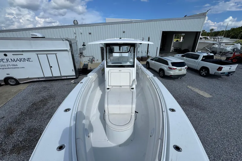Slide: The Image of 2023 Sea Hunt Gamefish 30 Coffin Box boat at a marina, surrounded by vehicles. - 21