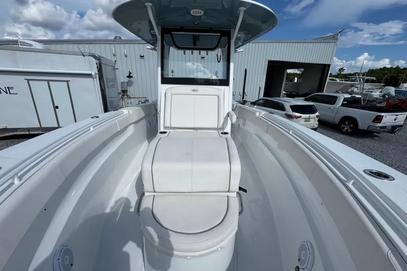 Slide: The Image of 2023 Sea Hunt Gamefish 30 Coffin Box boat interior with seating, docked outdoors. - 22