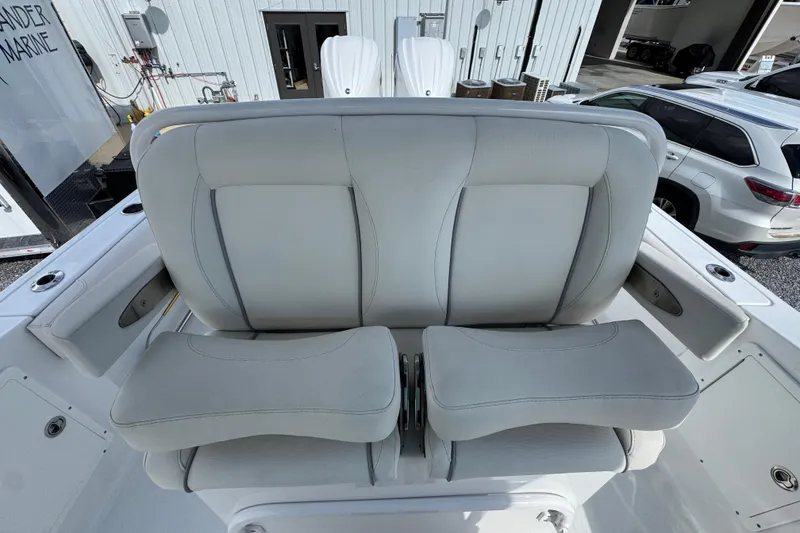 Slide: The Image of 2023 Sea Hunt Gamefish 30 Coffin Box boat seating, featuring plush gray upholstery. - 27