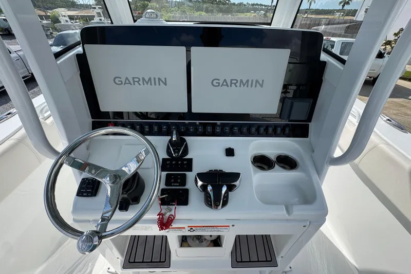 Slide: The Image of 2023 Sea Hunt Gamefish 30 Coffin Box helm with dual Garmin displays and steering wheel. - 30