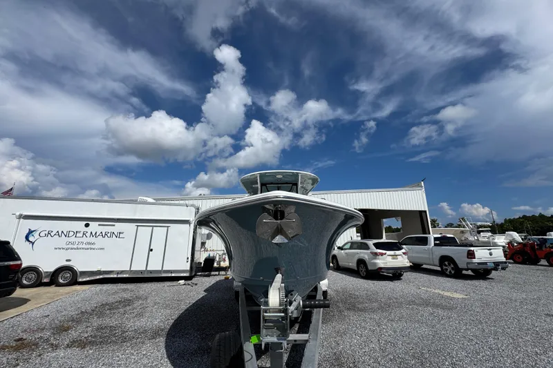 Slide: The Image of 2023 Sea Hunt Gamefish 30 Coffin Box boat at Grander Marine dealership under a blue sky. - 6