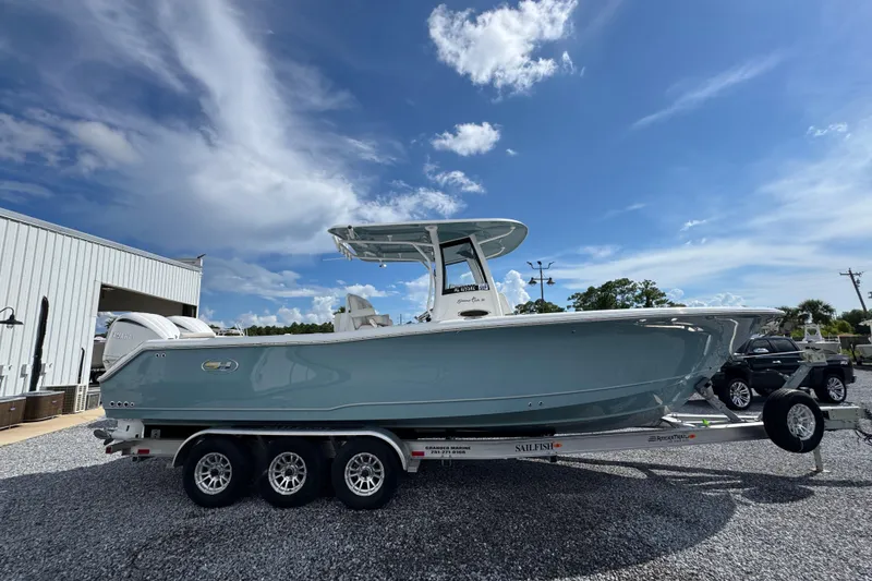 Slide: The Image of 2023 Sea Hunt Gamefish 30 Coffin Box boat on trailer under blue sky. - 9
