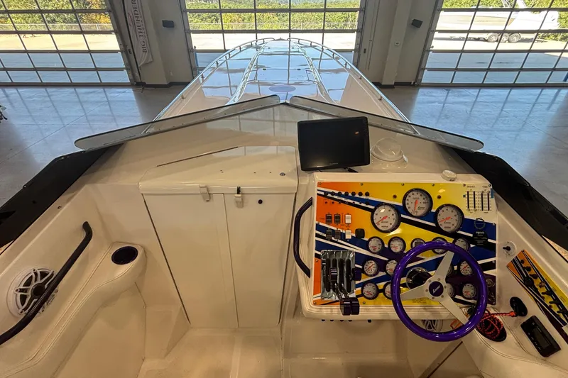 Slide: The Image of 2006 Fountain 42 Executioner boat cockpit with colorful dashboard and steering wheel. - 12