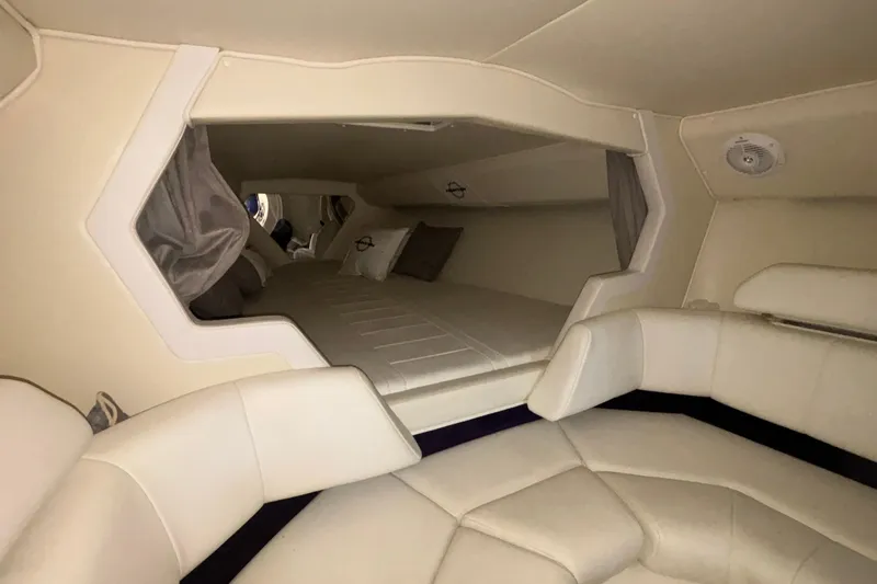 Slide: The Image of Interior cabin of 2006 Fountain 42 Executioner boat with beige seating and bedding. - 13