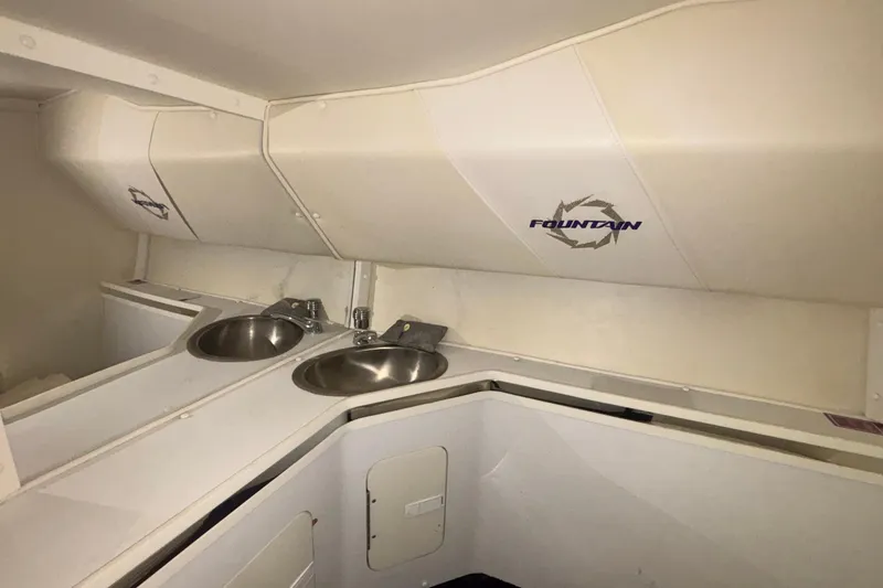 Slide: The Image of Interior of 2006 Fountain 42 Executioner boat with dual sinks and branded paneling. - 17
