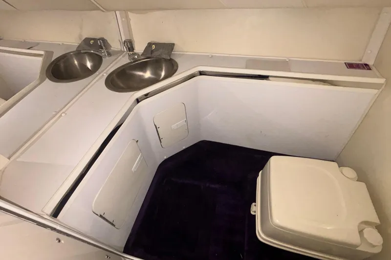 Slide: The Image of 2006 Fountain 42 Executioner boat interior with dual sinks and compact toilet. - 18