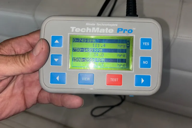Slide: The Image of Hand holding TechMate Pro diagnostic tool displaying RPM hours for Fountain 42 Executioner boat. - 22