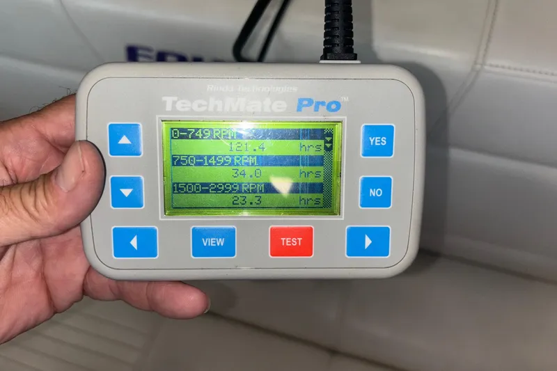 Slide: The Image of Hand holding TechMate Pro diagnostic tool displaying RPM data for Fountain 42 Executioner boat. - 23