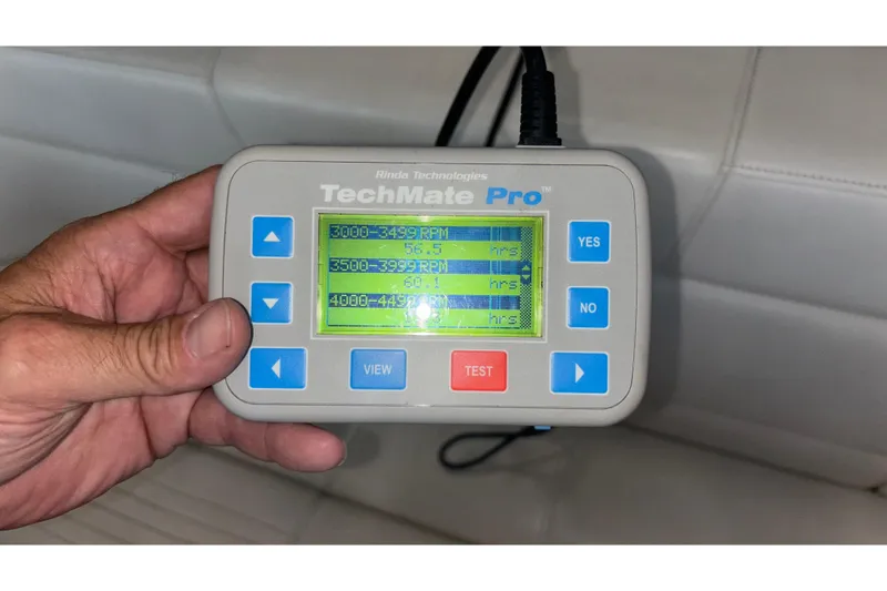Slide: The Image of Hand holding TechMate Pro diagnostic tool displaying RPM hours for Fountain 42 Executioner boat. - 24