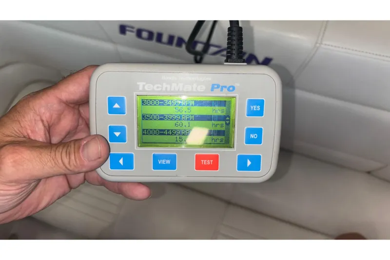 Slide: The Image of Hand holding TechMate Pro diagnostic tool displaying RPM data for Fountain 42 Executioner boat. - 25