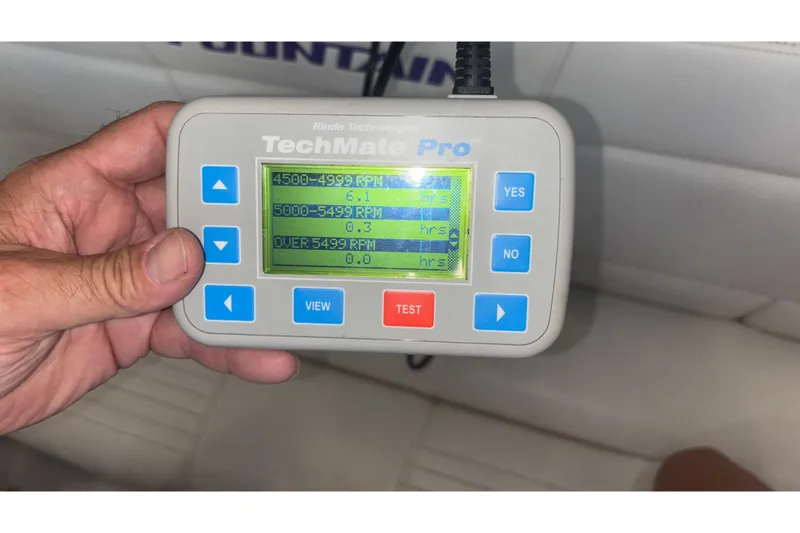 Slide: The Image of Hand holding TechMate Pro diagnostic tool displaying RPM data for Fountain 42 Executioner boat. - 27