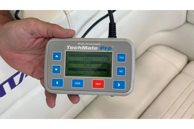 Slide: The Image of Hand holding TechMate Pro diagnostic tool inside 2006 Fountain 42 Executioner boat. - 28