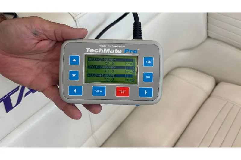 Slide: The Image of Hand holding TechMate Pro diagnostic tool inside 2006 Fountain 42 Executioner boat. - 29