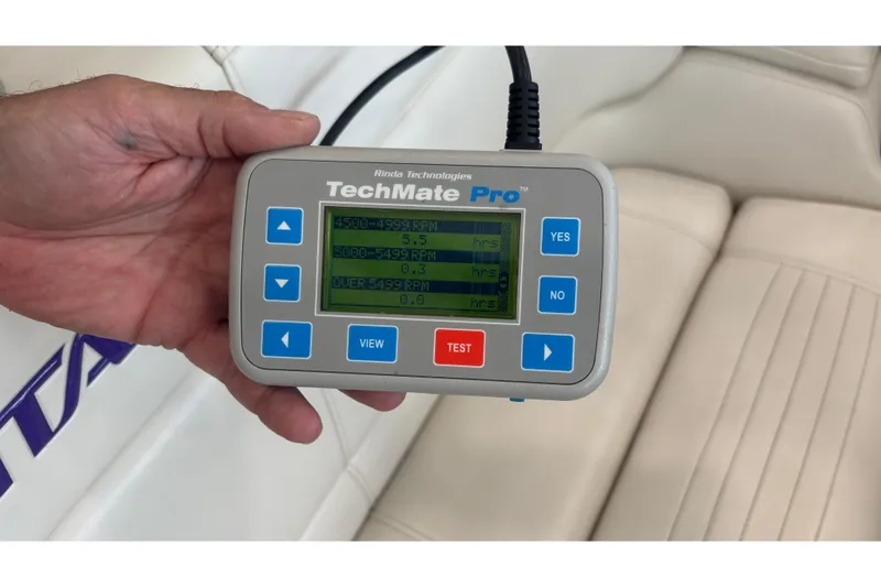 Slide: The Image of Hand holding TechMate Pro diagnostic tool displaying RPM data for 2006 Fountain 42 Executioner. - 30