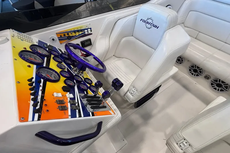 Slide: The Image of 2006 Fountain 42 Executioner boat cockpit with vibrant dashboard and white seating. - 9