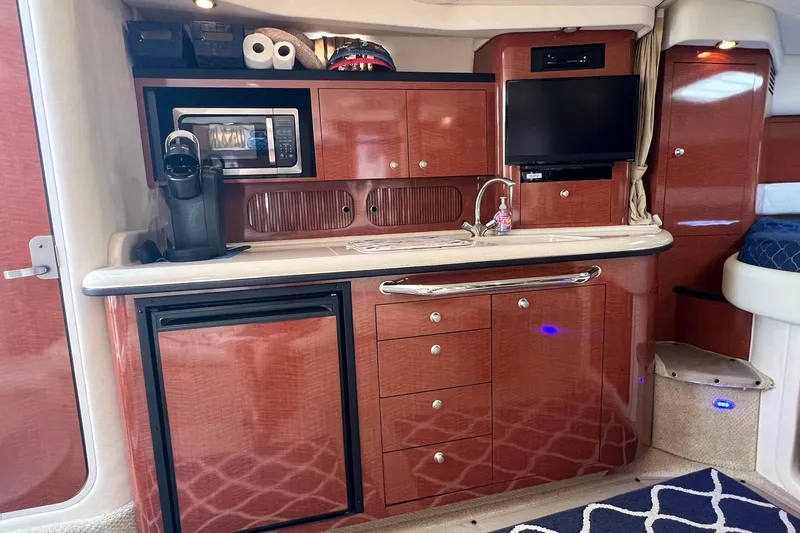 Slide: The Image of Luxurious interior of a 2005 Sea Ray 340 Sundancer yacht with kitchenette and modern amenities. - 11