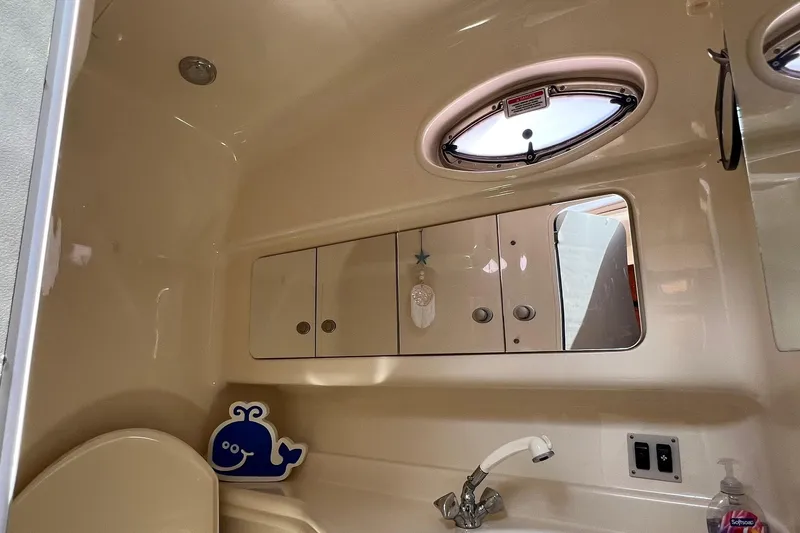 Slide: The Image of Interior of 2005 Sea Ray 340 Sundancer boat bathroom with sink and storage cabinets. - 15