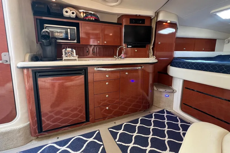 Slide: The Image of 2005 Sea Ray 340 Sundancer cabin interior with kitchenette, microwave, and bed. - 16