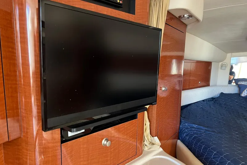 Slide: The Image of Interior of 2005 Sea Ray 340 Sundancer with TV and cozy bed area. - 17