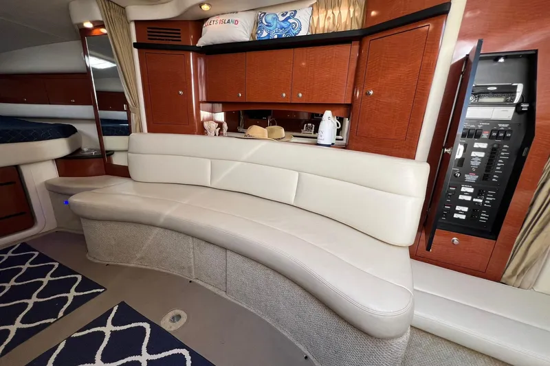 Slide: The Image of Luxurious interior of 2005 Sea Ray 340 Sundancer yacht with plush seating and wooden cabinetry. - 19