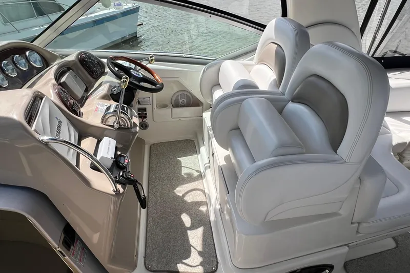 Slide: The Image of 2005 Sea Ray 340 Sundancer helm with dual seats and modern controls. - 2