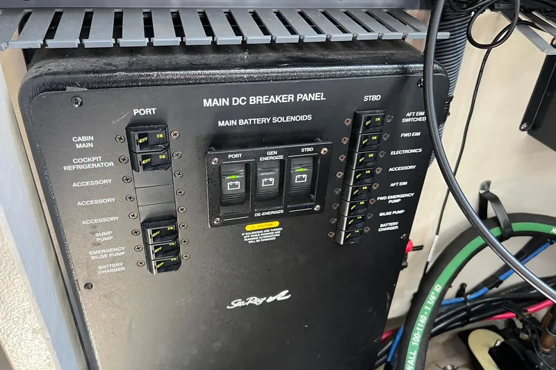 Slide: The Image of Main DC breaker panel on 2005 Sea Ray 340 Sundancer boat, showing switches and solenoids. - 22