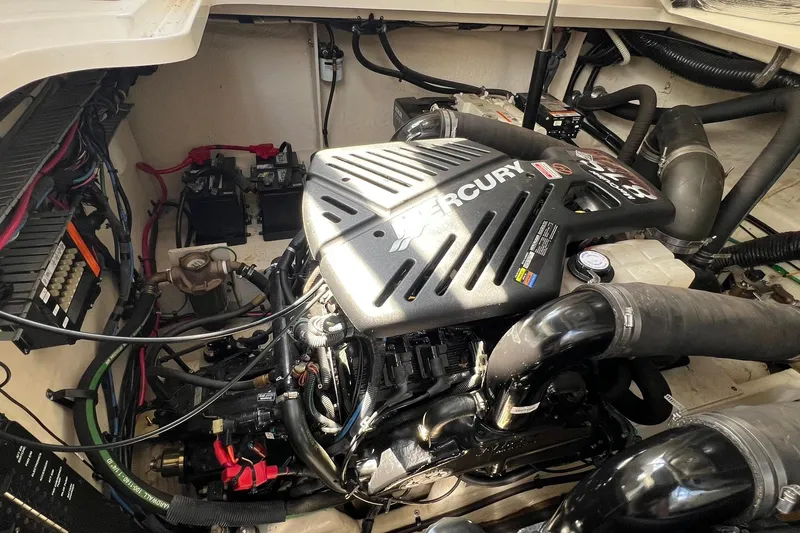 Slide: The Image of Engine compartment of a 2005 Sea Ray 340 Sundancer with Mercury engine components. - 26