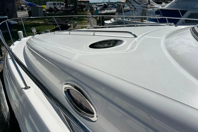 Slide: The Image of 2005 Sea Ray 340 Sundancer yacht deck with sleek design and chrome railings. - 27