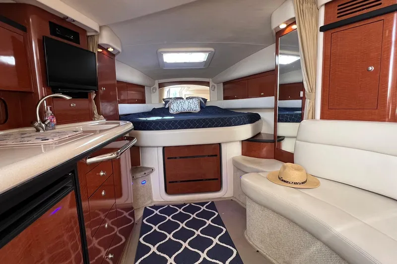 Slide: The Image of Luxurious interior of 2005 Sea Ray 340 Sundancer yacht with bed, seating, and kitchenette. - 30