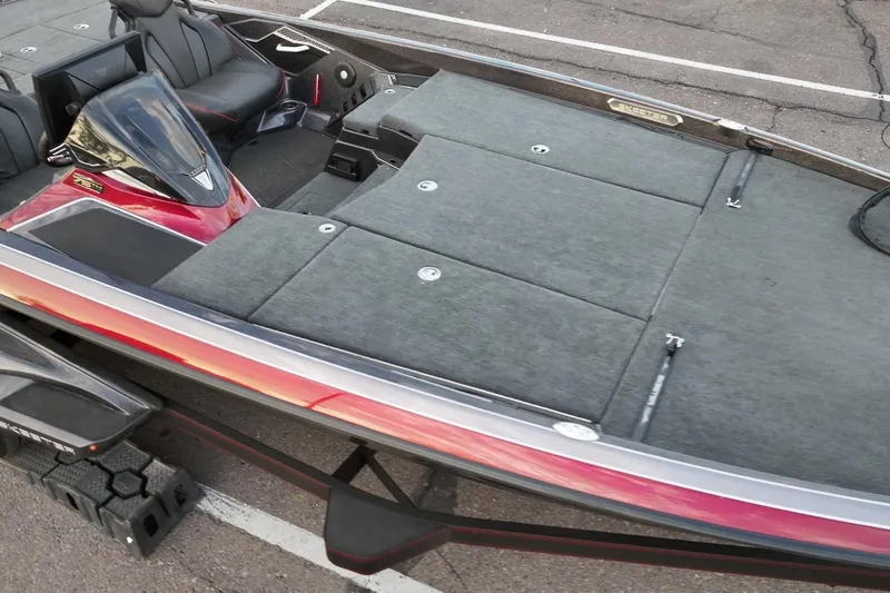 Slide: The Image of 2023 Skeeter FXR21 boat with spacious deck and sleek design in parking lot. - 10