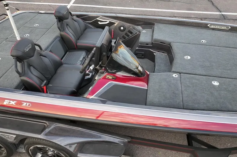 Slide: The Image of 2023 Skeeter FXR21 boat interior with dual seats and sleek dashboard design. - 11