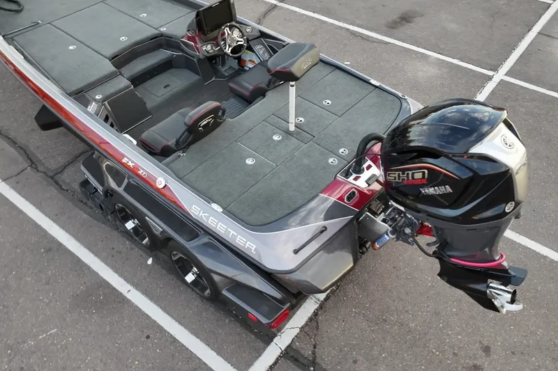 Slide: The Image of 2023 Skeeter FXR21 bass boat with Yamaha outboard engine, parked in a lot. - 16