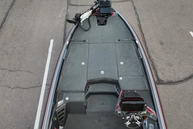 Slide: The Image of 2023 Skeeter FXR21 boat deck with advanced navigation equipment, parked on asphalt. - 18