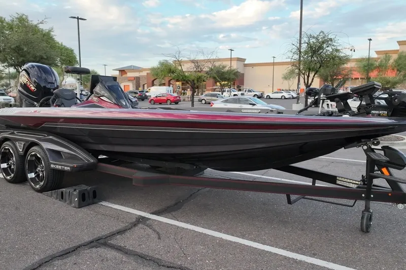 Slide: The Image of 2023 Skeeter FXR21 boat on trailer in parking lot, showcasing sleek design and modern features. - 19