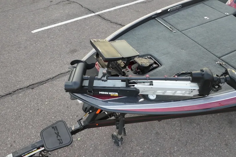 Slide: The Image of 2023 Skeeter FXR21 boat with Minn Kota trolling motor on asphalt. - 2
