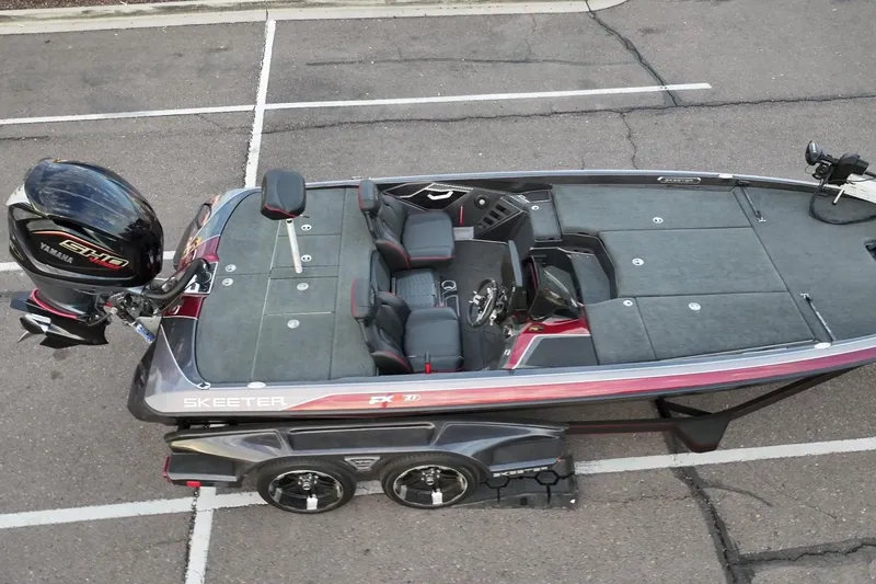 Slide: The Image of 2023 Skeeter FXR21 bass boat with Yamaha engine, parked in a lot, aerial view. - 20