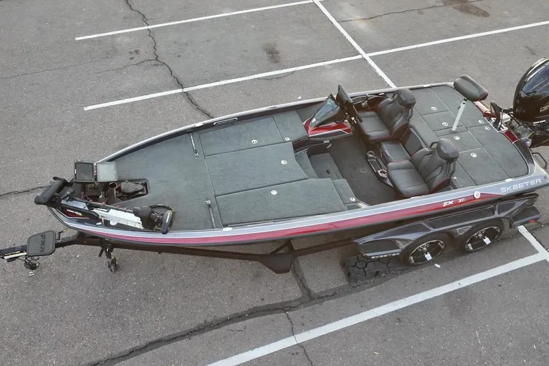 Slide: The Image of 2023 Skeeter FXR21 bass boat in parking lot, showcasing sleek design and modern features. - 21