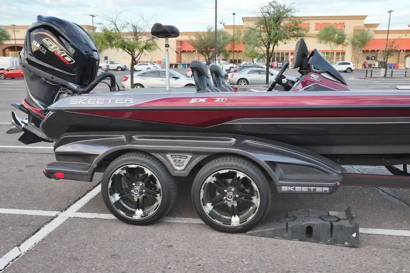 Slide: The Image of 2023 Skeeter FXR21 boat with Yamaha engine in parking lot. - 5