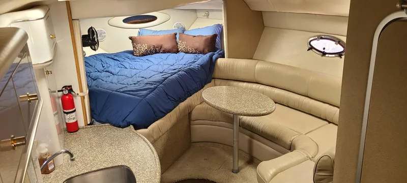 Slide: The Image of Interior of 1998 Maxum 3000 SCR boat with cozy bed and seating area. - 12