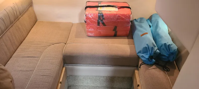 Slide: The Image of Interior seating area of a 1998 Maxum 3000 SCR boat with safety equipment. - 16