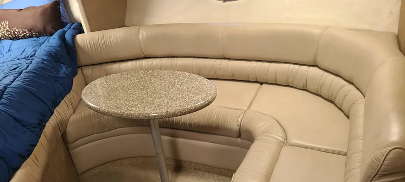 Slide: The Image of 1998 Maxum 3000 SCR interior with beige leather seating and small round table. - 17