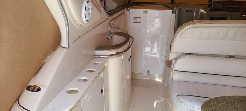 Slide: The Image of 1998 Maxum 3000 SCR boat interior with sink, seating, and storage. - 6