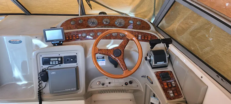Slide: The Image of 1998 Maxum 3000 SCR boat dashboard with wood accents and navigation equipment. - 8