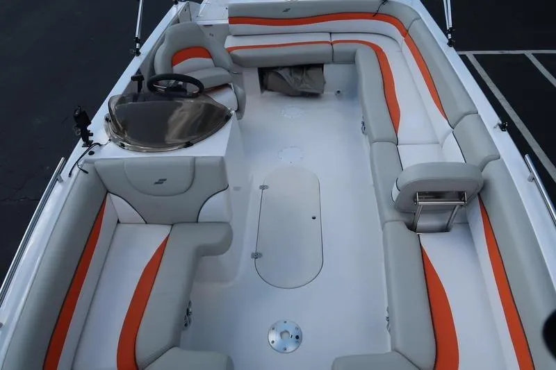 Slide: The Image of 2020 Starcraft MDX OB 211 E OB boat interior with orange and gray seating. - 5