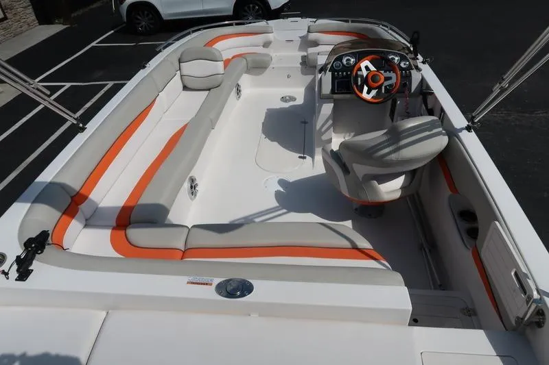 Slide: The Image of 2020 Starcraft MDX OB 211 E OB boat interior with orange and gray seating. - 7