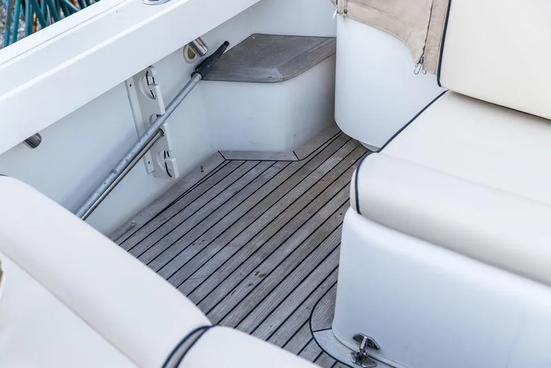 Slide: The Image of 2008 Hunt Yachts Surfhunter 29 interior with cushioned seating and wooden flooring. - 13